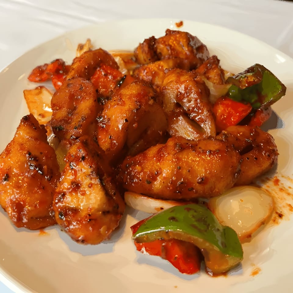 Royal India Palace's chili chicken, featuring crispy chicken pieces with bell peppers and onions.
